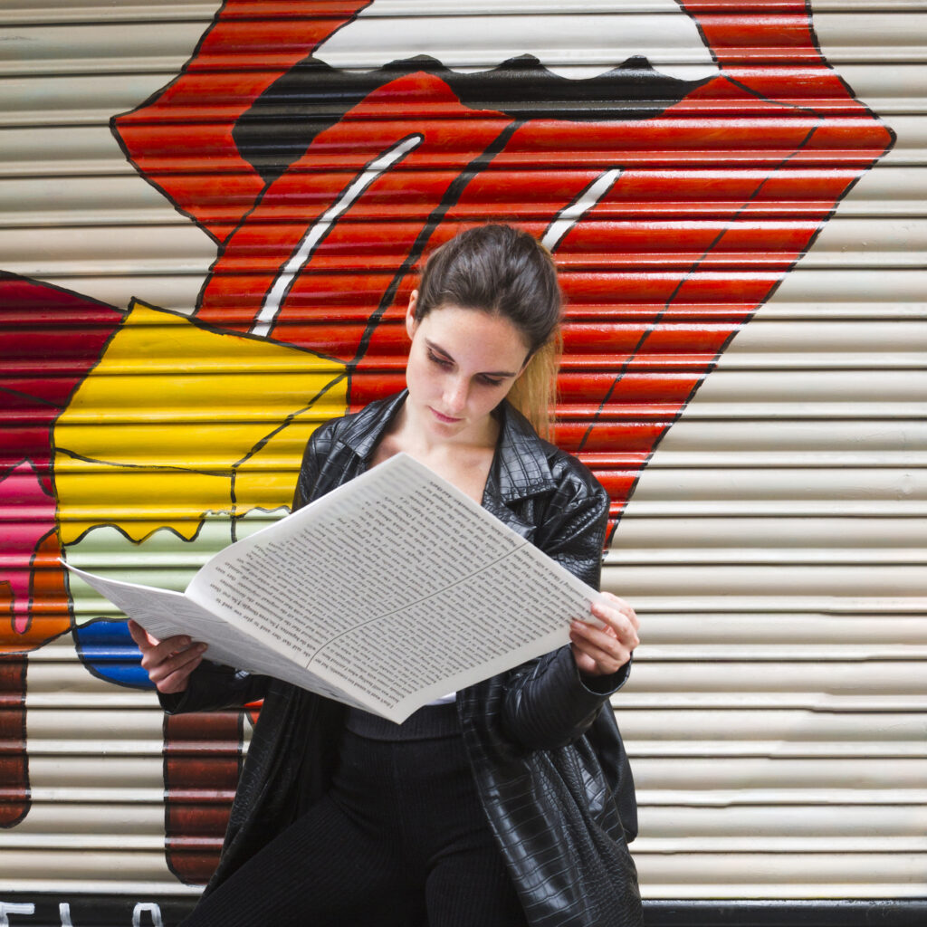 medium-shot-standing-woman-reading-paper